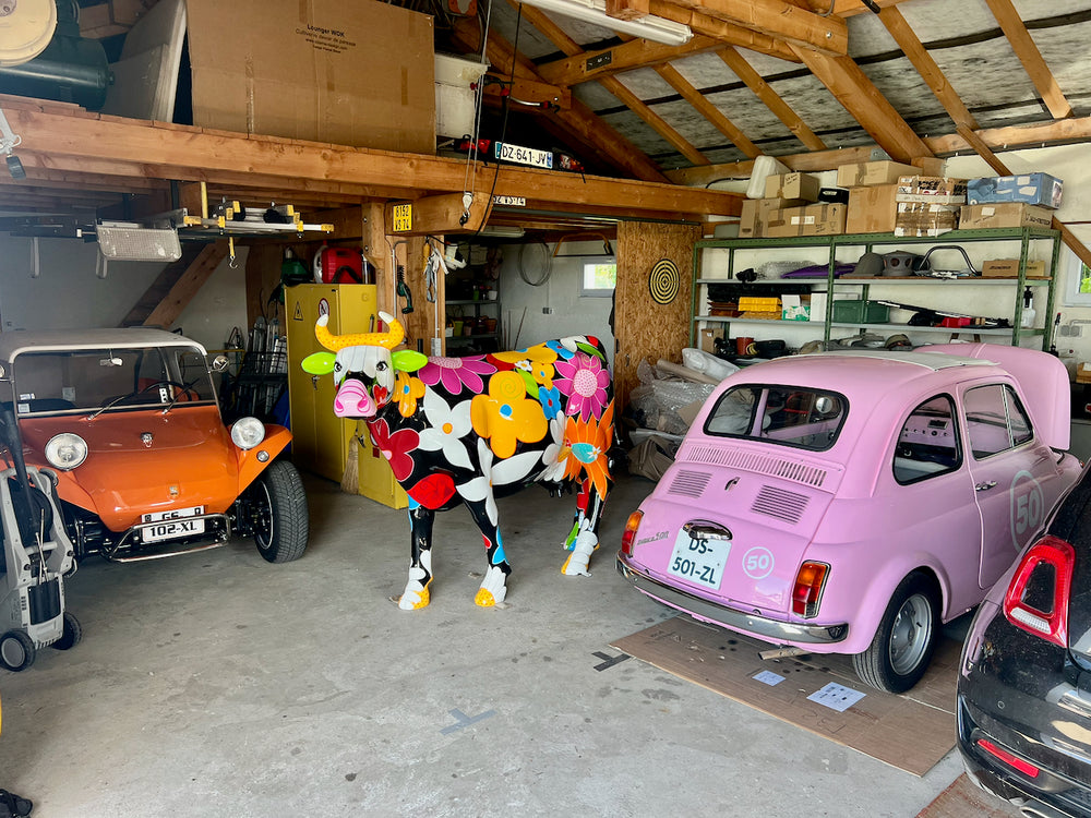 Vache Kuhtag à fleurs dans un garage de collection
